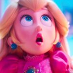 An animated blonde woman in a pink dress looks shocked