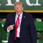 President Donald Trump wears a gold medal from Olympic speedskater Jordan Stolz at Custer Farms in Chippewa Falls, Wisconsin, on June 5. (AP Photo/Glen Stubbe)