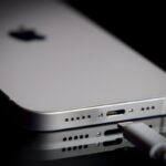 A Apple Lightning port charging cable is seen with with an iPhone.