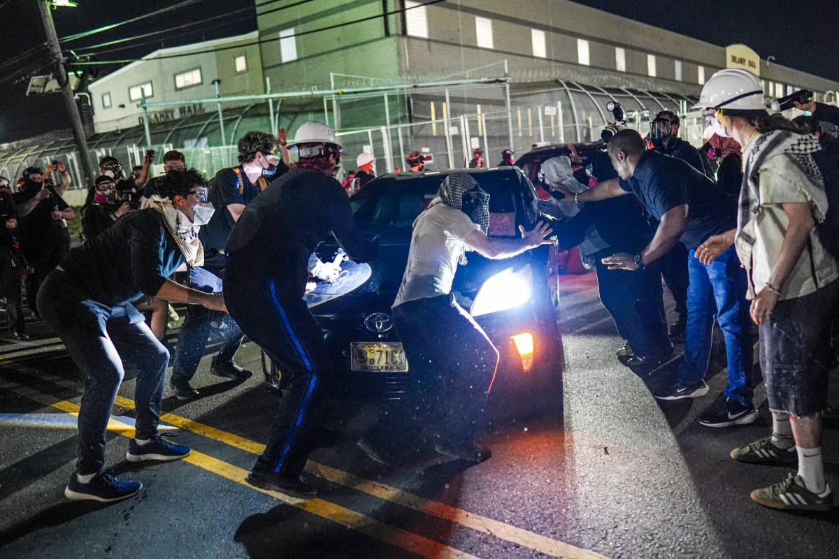 Protesters try to block a vehicle from leaving Delaney Hall, which is being used as an Immigration and Customs Enforcement (ICE) detention center, in Newark, New Jersey, on June 5, 2026.