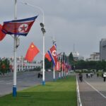 The national flags of North Korea and China are displayed on a street in Pyongyang on June 8, 2026, in preparation for the arrival of Chinese President Xi Jinping state visit on June 8-9.
