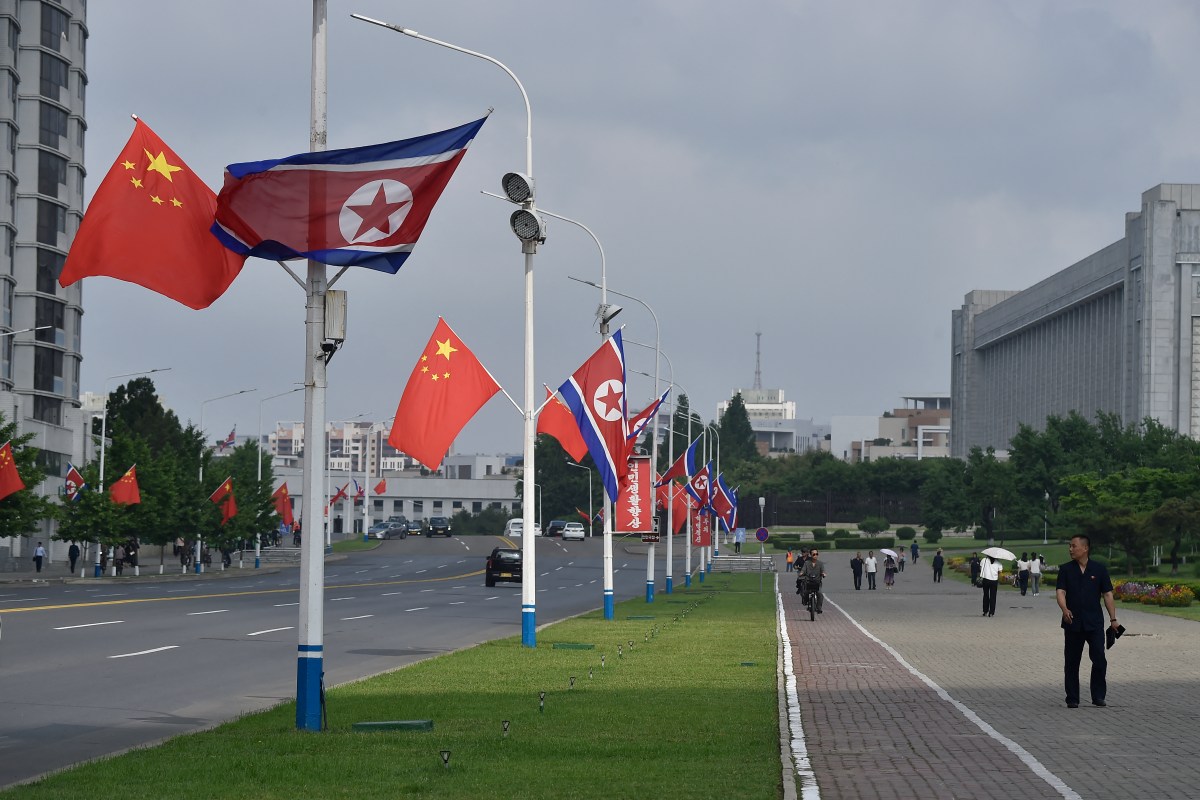 The national flags of North Korea and China are displayed on a street in Pyongyang on June 8, 2026, in preparation for the arrival of Chinese President Xi Jinping state visit on June 8-9.