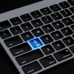 IA finge um problema crescente na Apple Books e na Amazon | A foto mostra um teclado Apple com uma tecla AI brilhante