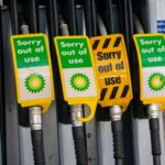 Signs warn drivers that gas pumps are out of order.