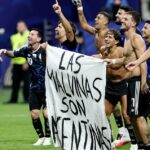 Lisandro Martinez e Giovani Lo Celso, que jogaram por clubes da Premier League, comemoram com uma faixa reivindicando as Ilhas Malvinas