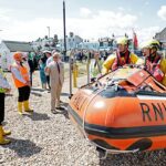 Rei Charles assiste à demonstração do lançamento de um barco salva-vidas durante sua visita à estação de barcos salva-vidas Walmer RNLI em Deal, Kent, em julho de 2025