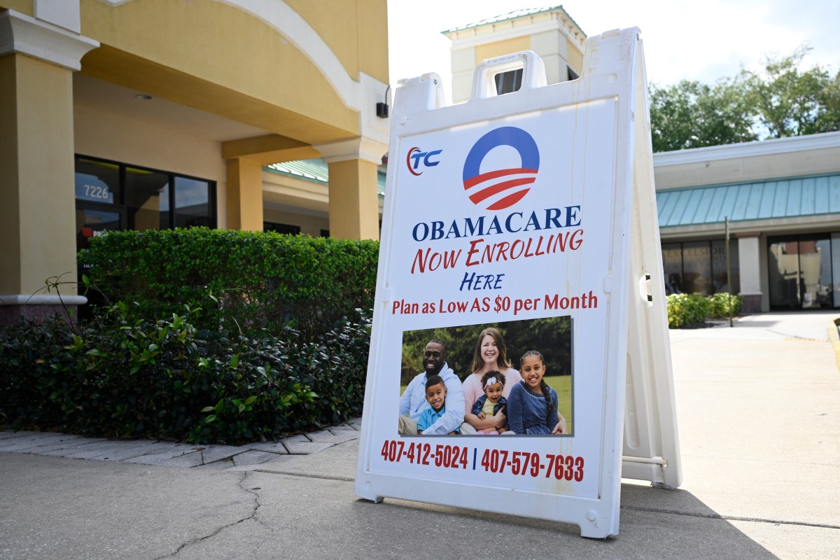 An Obamacare sign is displayed outside an insurance agency on November 12, 2025 in Miami, Florida.