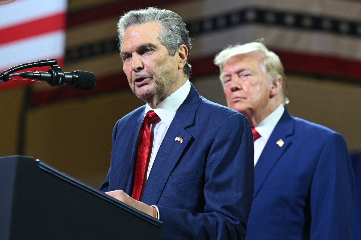 President Donald Trump, background, looks on as Republican gubernatorial candidate Rick Jackson speaks at Wheeler High School in Marietta, Georgia, on July 22. (Photo by Saul Loeb/AFP via Getty Images)