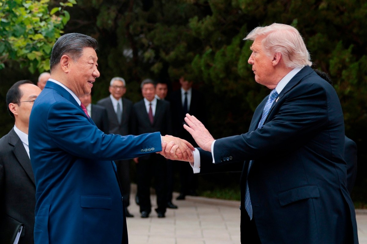 U.S. President Donald Trump (R) shakes hands with Chinese President Xi Jinping in Beijing on May 15, 2026.
